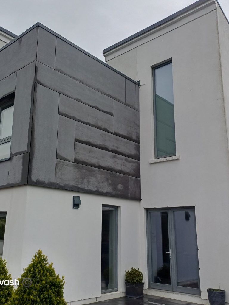 Dark cladding and render with algae, before a softwash in Cork