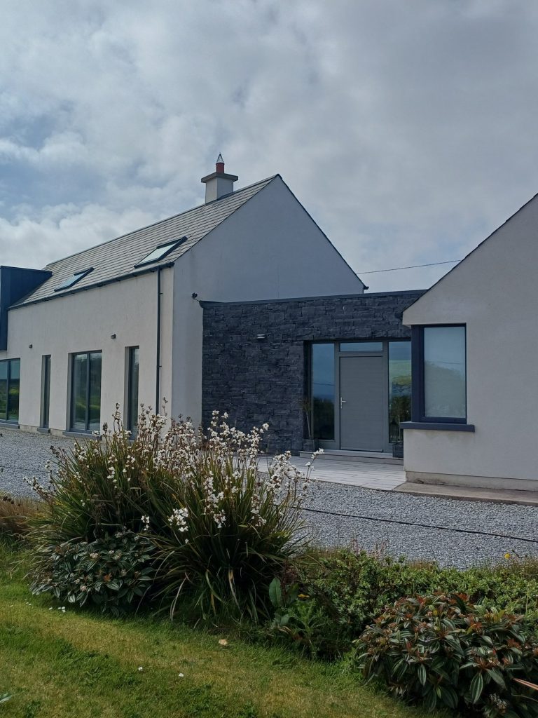 House with slate cladding and white render after a Gold Standard softwash in Cork
